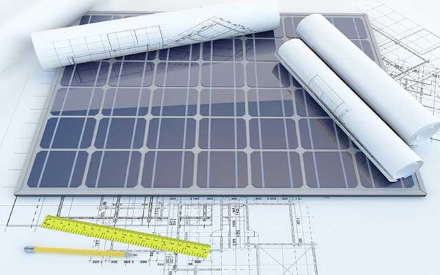 Solar panel resting on architectural blueprints